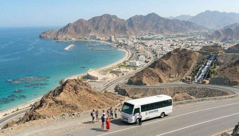 White 30 seater Toyota Coaster bus for rent with driver parked at an East Coast mountain viewpoint in Khor Fakkan by Star Bus Rental
